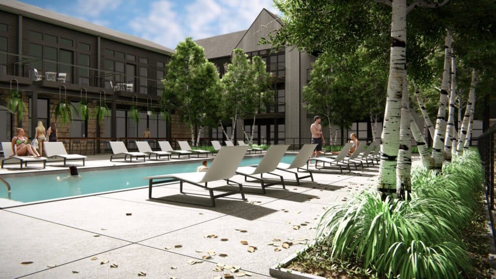 Outdoor pool area with several white lounge chairs, people relaxing, and trees lining the poolside. A modern building is in the background under a partly cloudy sky.
